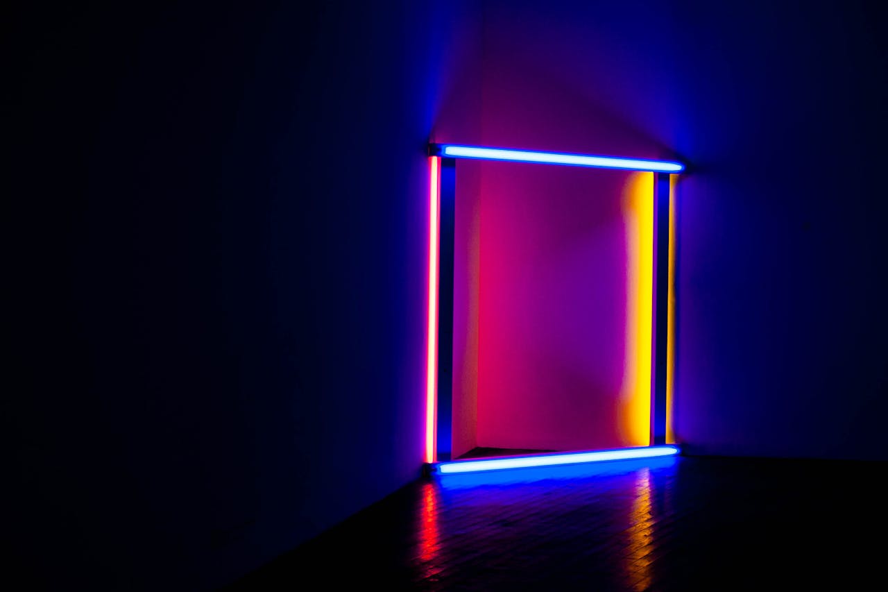 Colorful neon light installation casting vivid reflections in a dark room atmosphere.